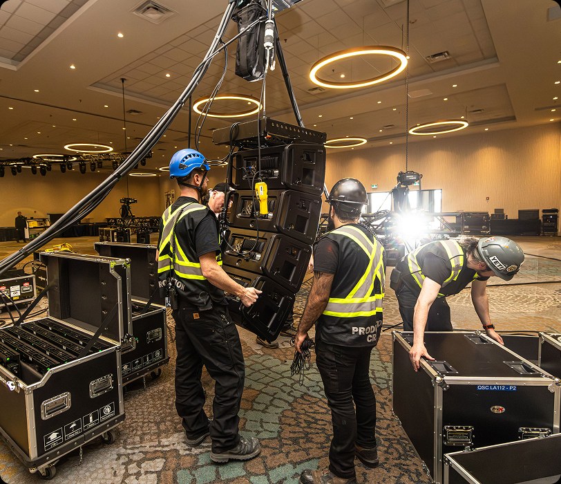 People working installing sound equipment